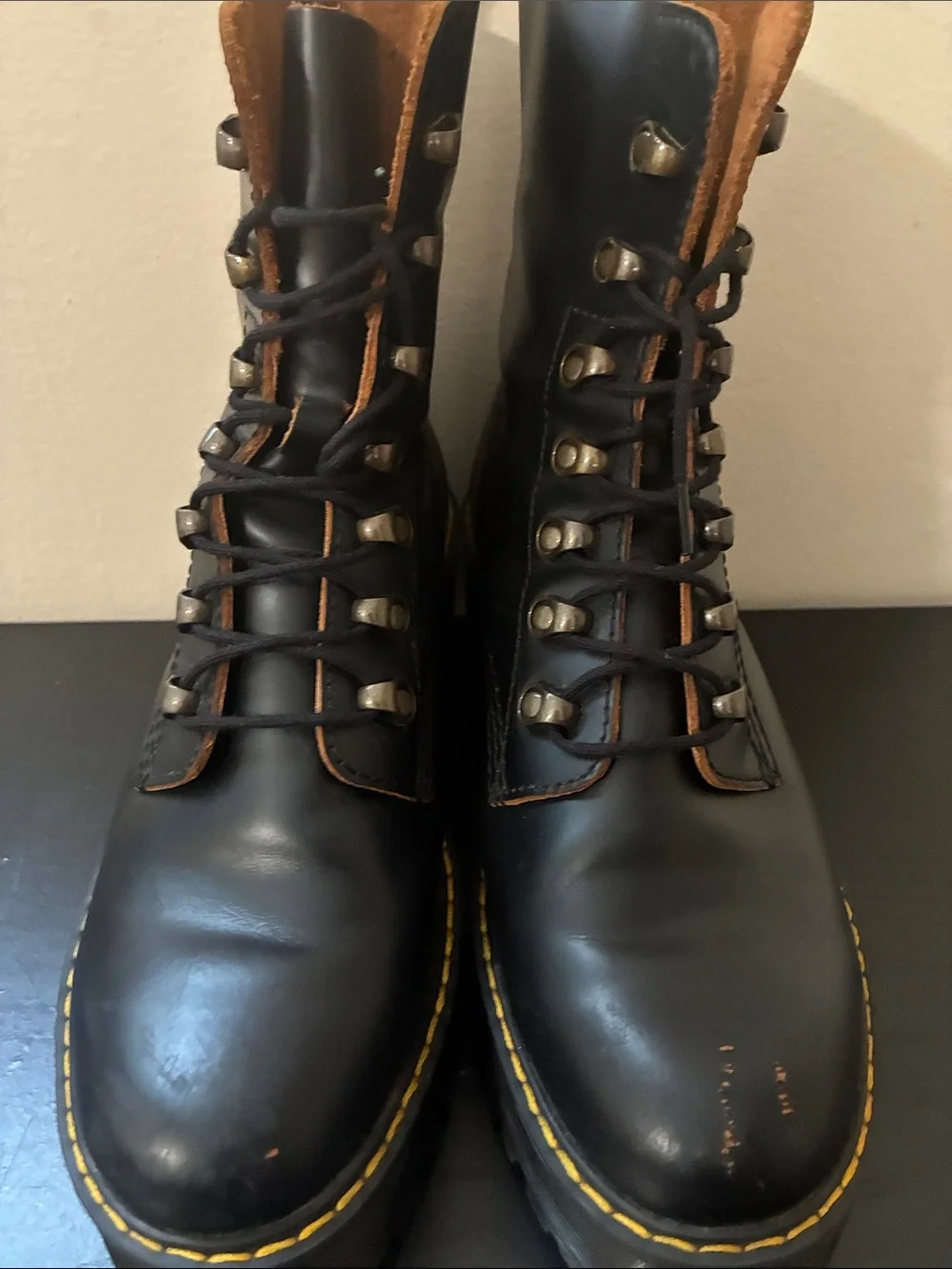 Dr. Martens Leona platform boots featuring a black smooth leather size 9